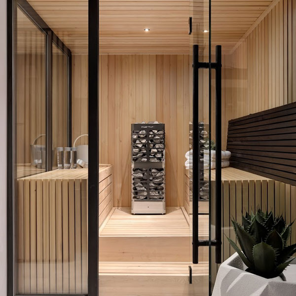 Homecraft electric sauna heater in a modern wooden sauna near glass paneling