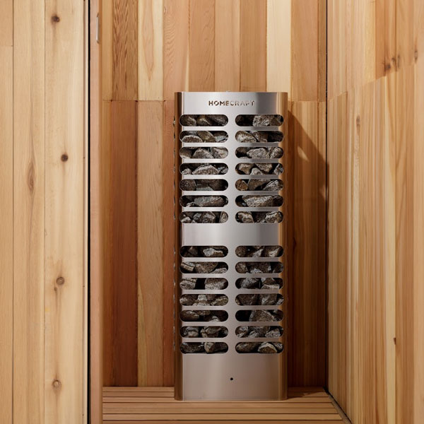 Slim stainless electric sauna heater unit with stacked gray stones behind curved vents