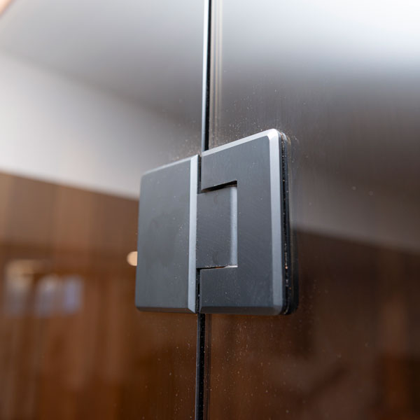 Close-up of sauna glass door latch handle hardware