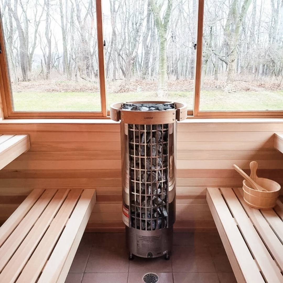 Harvia Cilindro PC90 cylindrical sauna heater with metal frame and stacked stones