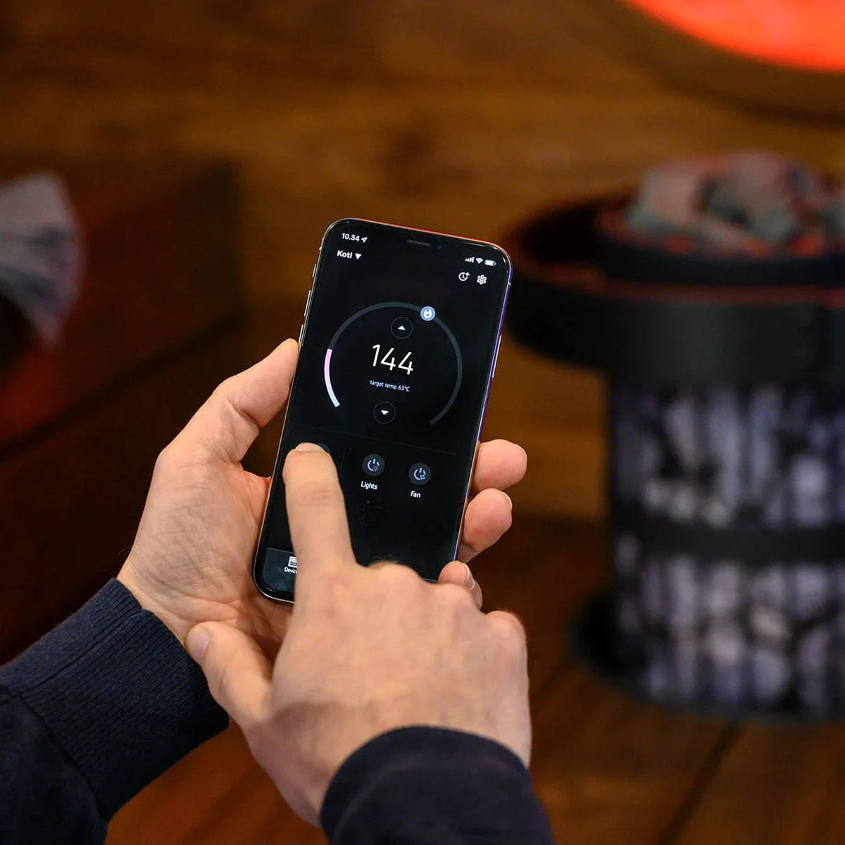 Smartphone displaying sauna heater control app for temperature settings