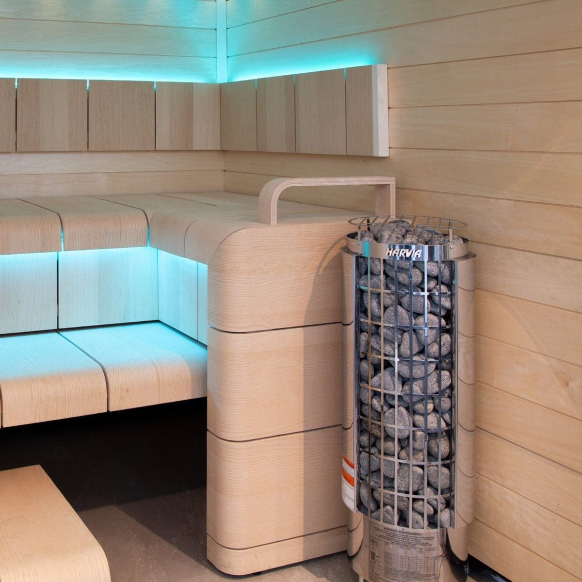 Cylindrical sauna heater with metal stone cage installed in a corner sauna