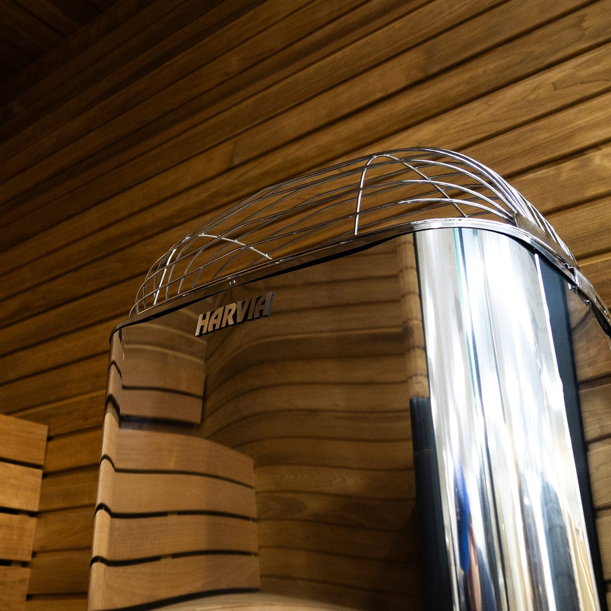 Harvia sauna heater side view with wire guard and stainless body