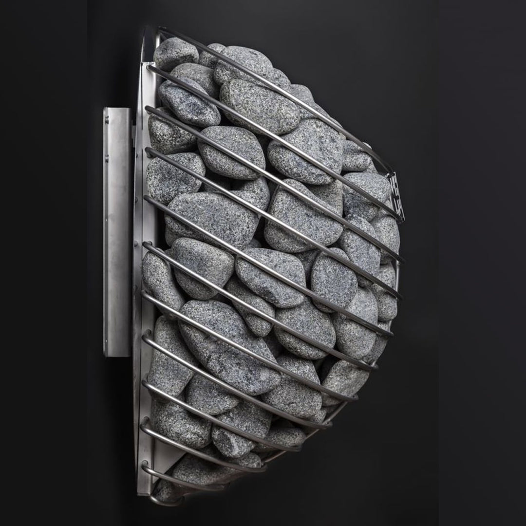 Close-up of a sauna heater cage filled with grey stones