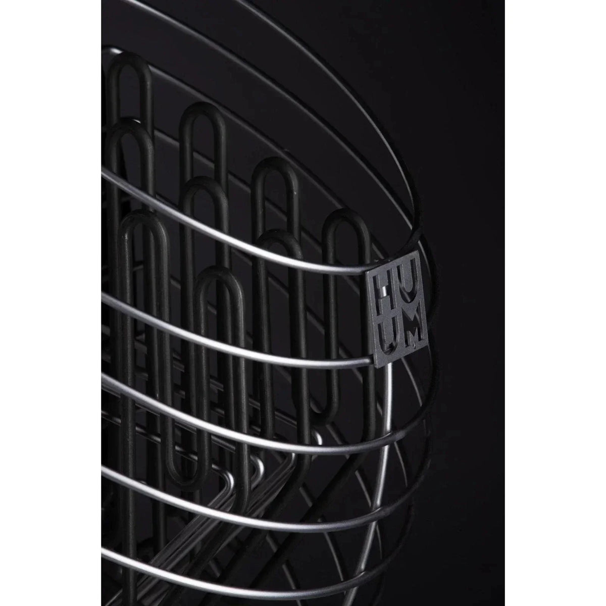 Black sauna heater interior with metal heating wires and HUUM logo