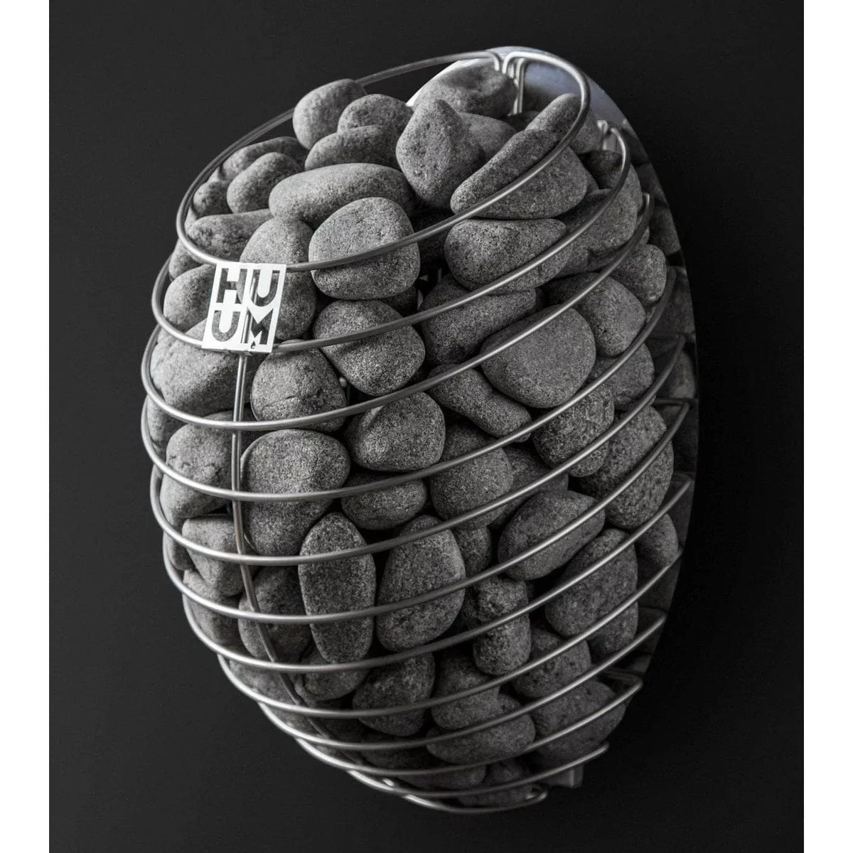 Electric sauna heater with gray sauna stones and HUUM logo label