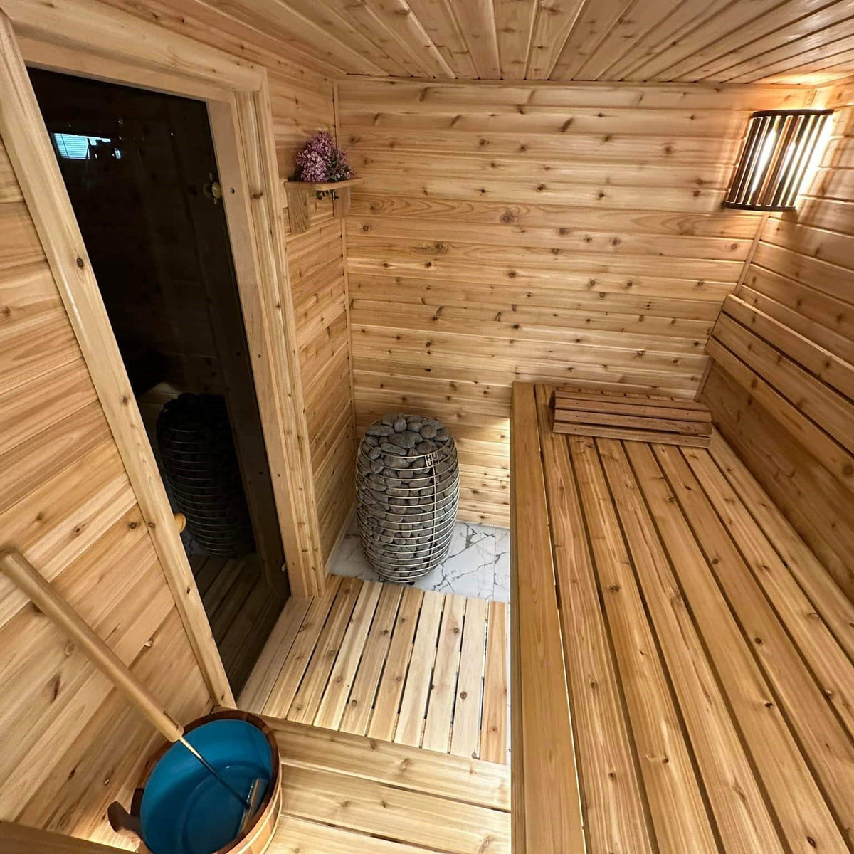 Electric sauna heater stones in a corner sauna installation