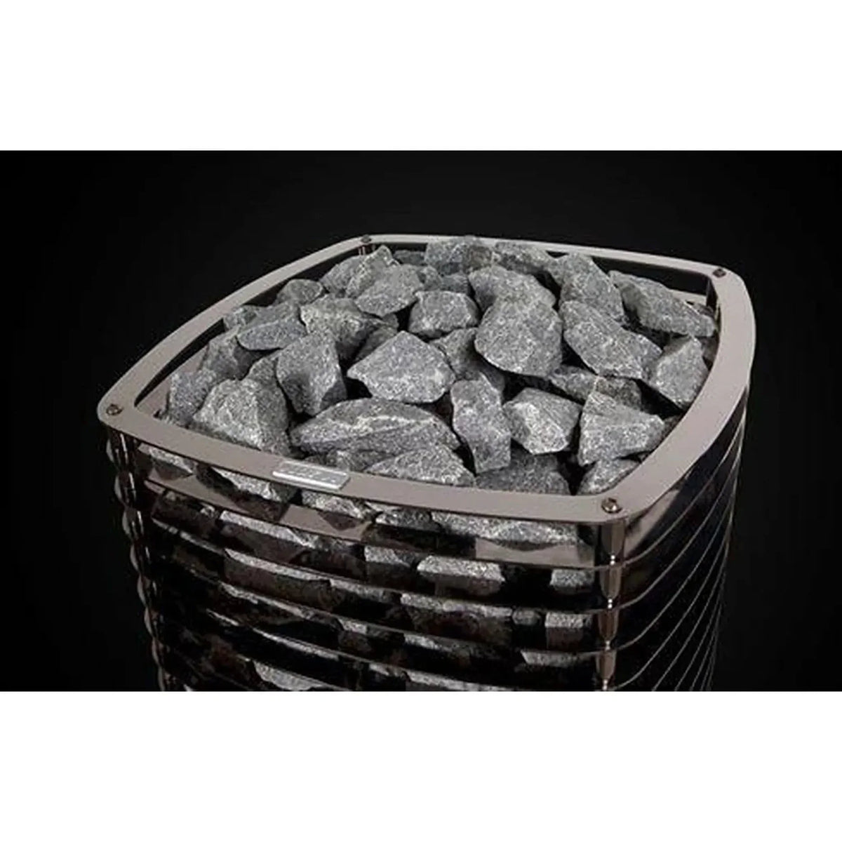 Top view of black sauna heater with gray stone bed and metal rim supports