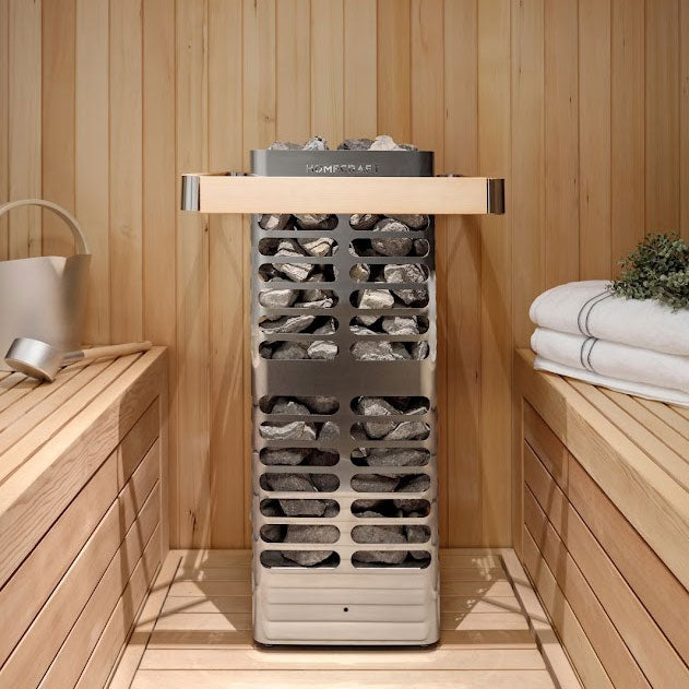 Homecraft electric sauna heater standing in a wooden sauna with dark rocks on top