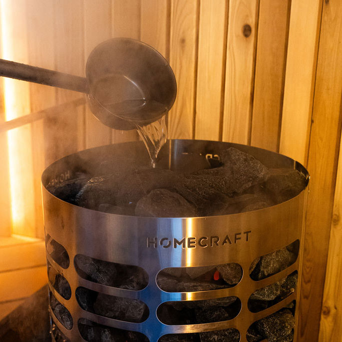 Cylindrical sauna heater with glowing interior and rock-filled top, HOMECRAFT