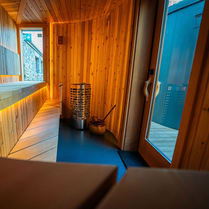 Homecraft electric sauna heater cylinder with stone rocks inside wooden sauna