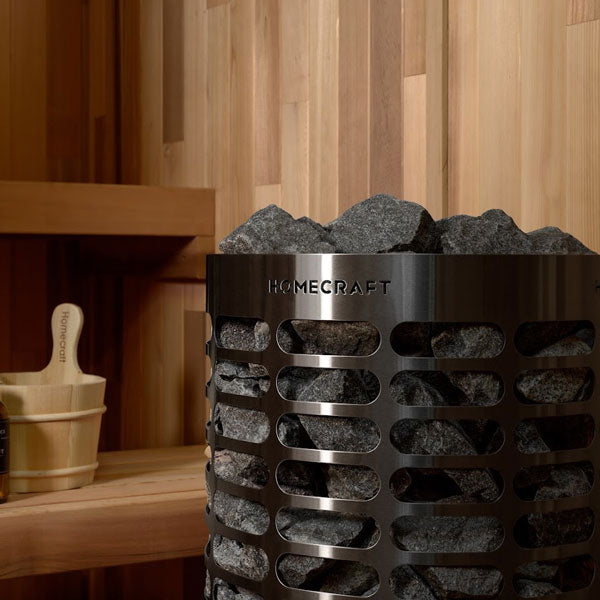 Cylindrical sauna heater with stacked rocks and HOMECRAFT band on perforated metal drum