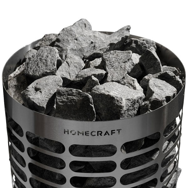 Rock-filled cylindrical sauna heater with perforated metal drum and HOMECRAFT logo