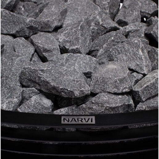 Narvi label on the black rim of a sauna heater filled with gray rocks