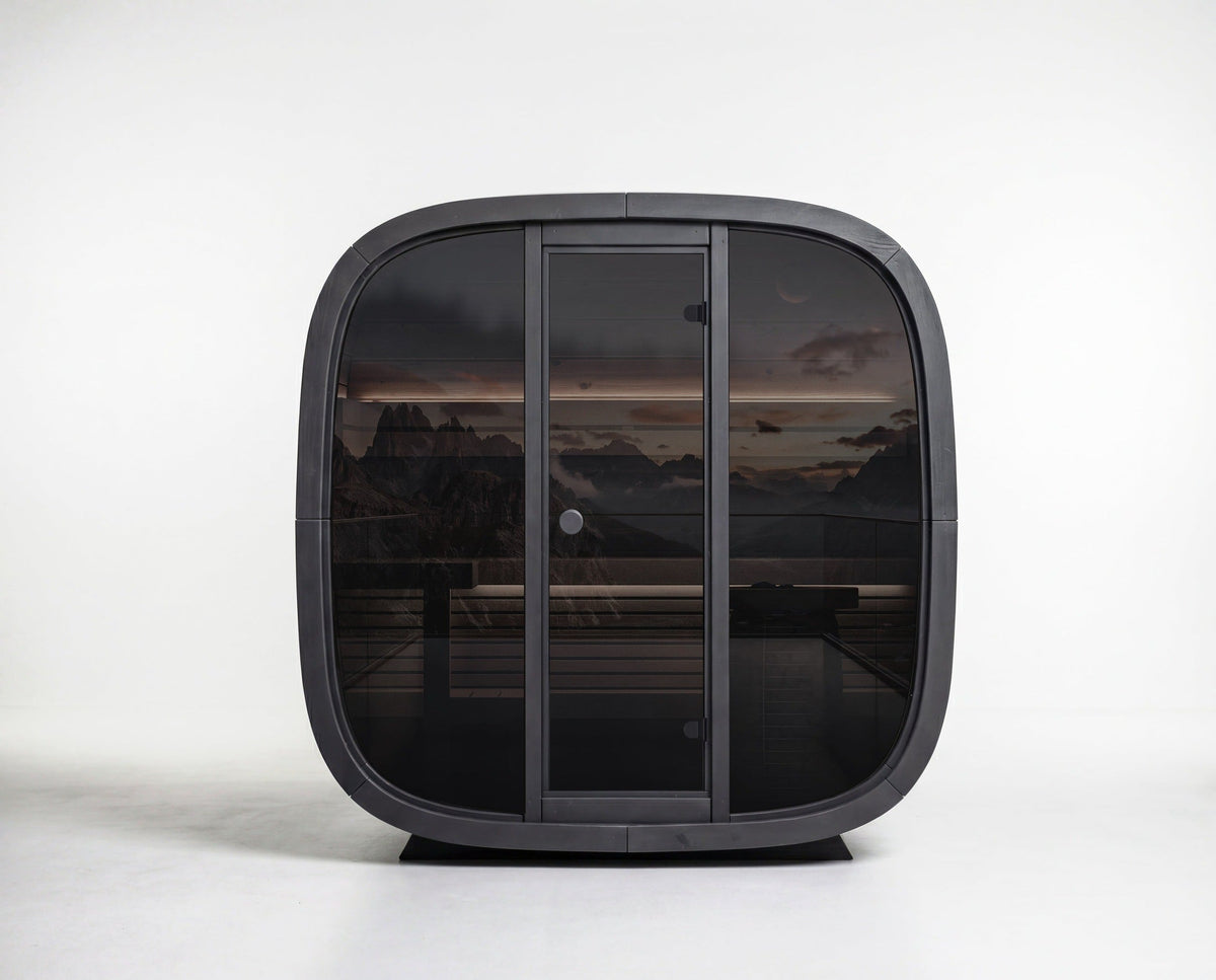 SASE-BC-5 Leil Black Cube Classic 4-person outdoor sauna kit with black Thermowood exterior, smoked glass front, modern wood sauna cabin for backyard wellness and relaxation