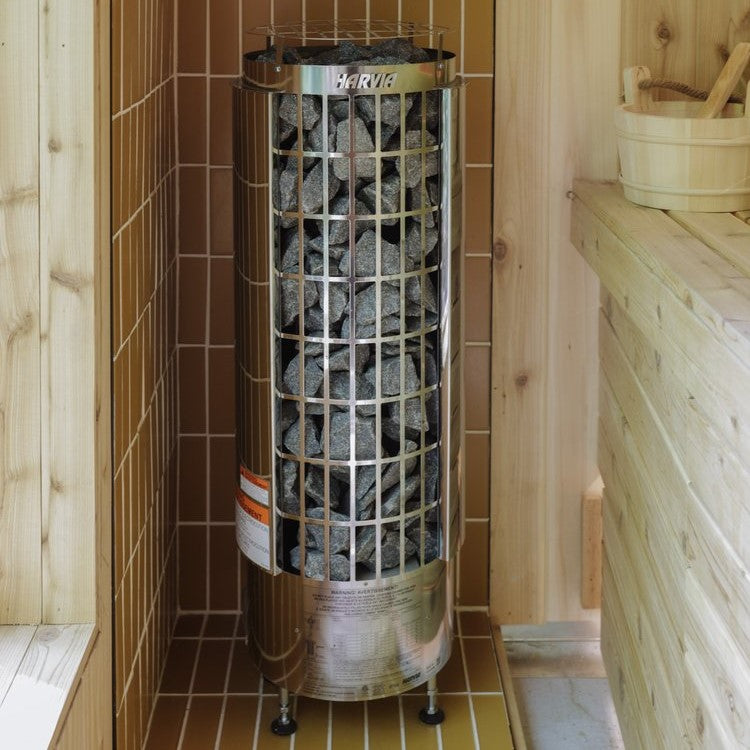 Harvia sauna heater in corner with stacked dark stones inside metal cylinder