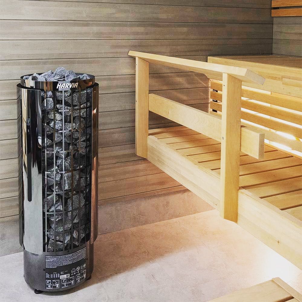 Freestanding sauna heater cylinder with black stone basket and stone-filled core
