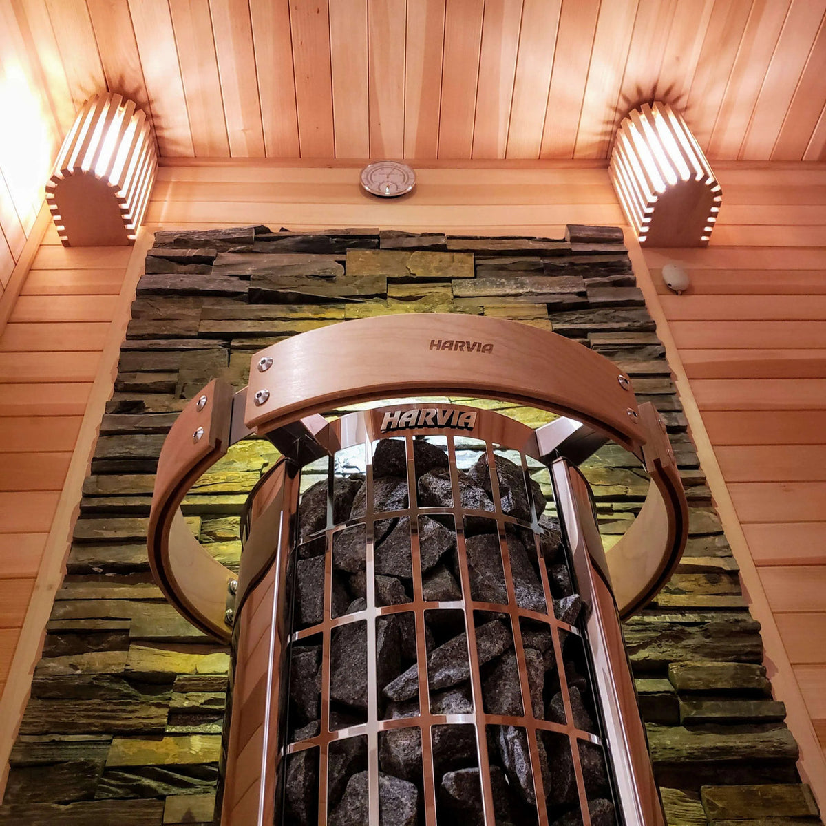 Sauna heater top view with HARVIA label over a stone-filled heater