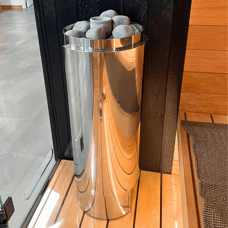 Chrome Harvia sauna heater with gray stones and visible heating glow