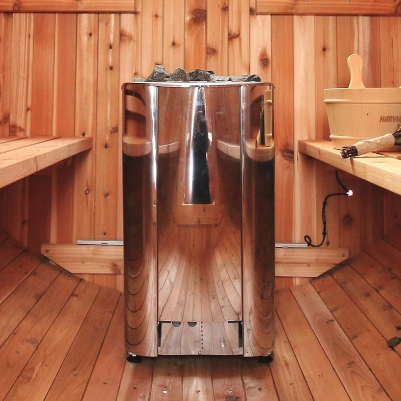 Electric sauna heater with stainless steel housing and stone basket in a wooden sauna