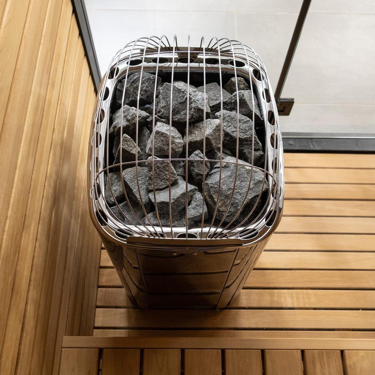 Harvia sauna heater with stone-filled wire cover and metal housing