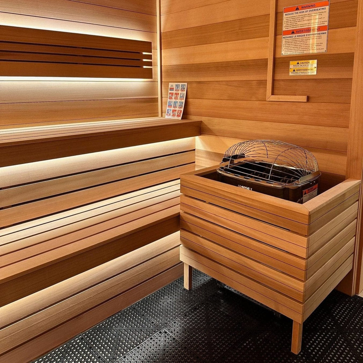 Harvia electric sauna heater installed in wooden sauna corner