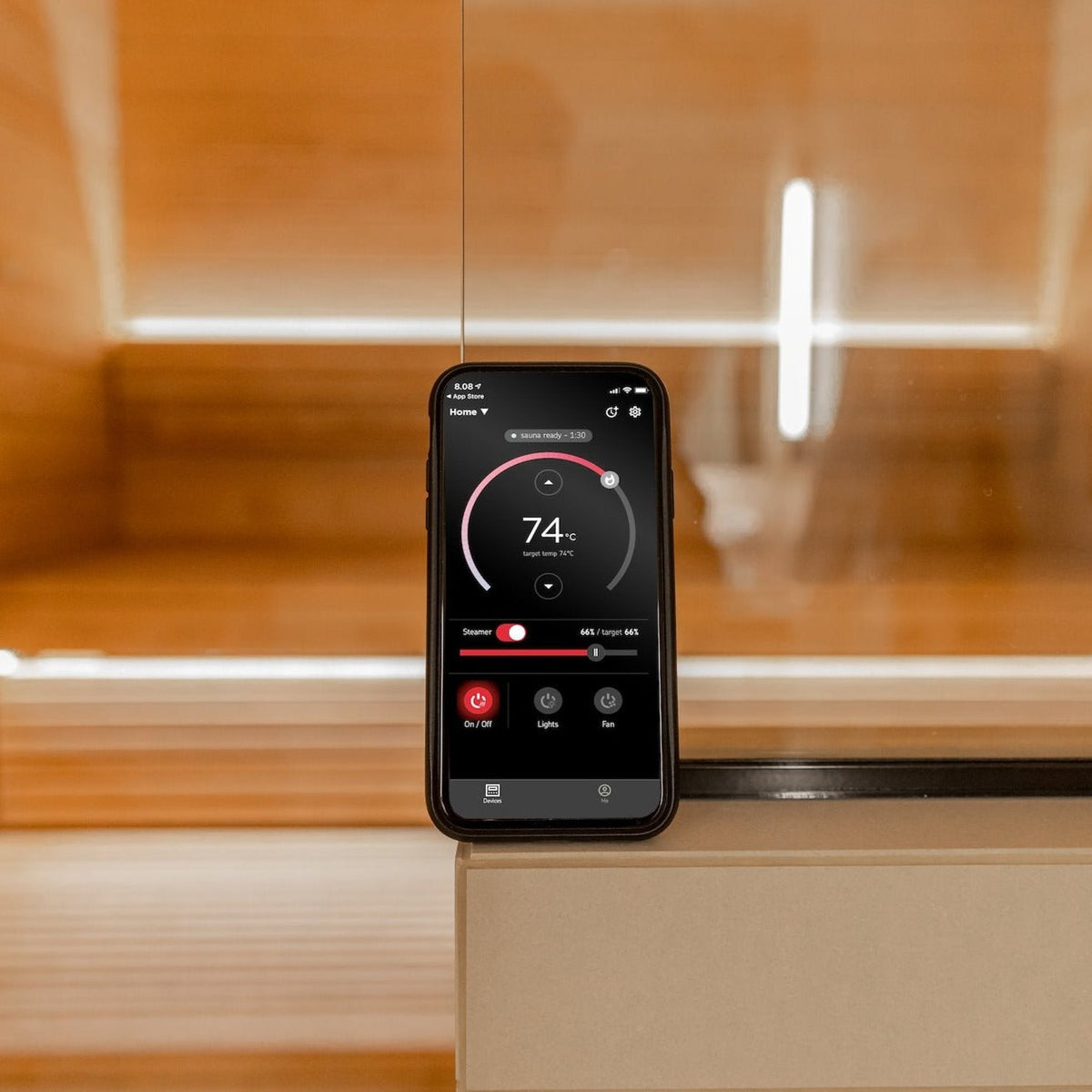 Sauna control device with touchscreen display showing 74°F