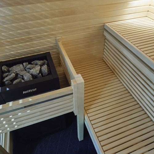 Electric sauna heater with stones along the sauna bench area