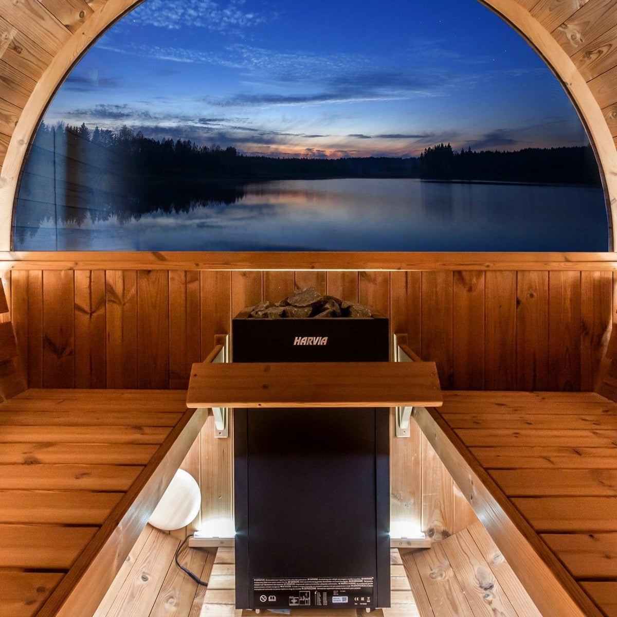 Electric sauna heater centered in wooden sauna, stones visible on top