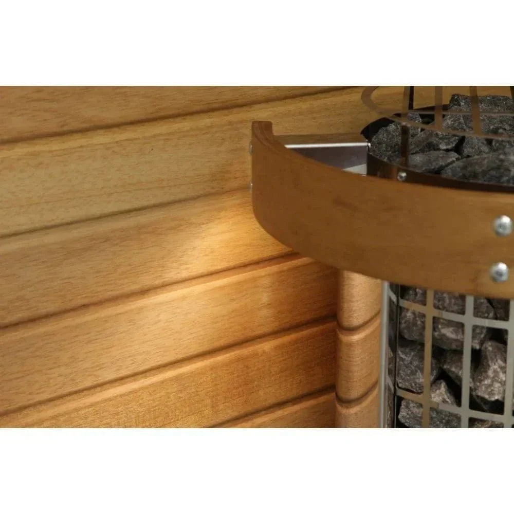 Side view of sauna heater with curved metal guard bars and stone basket