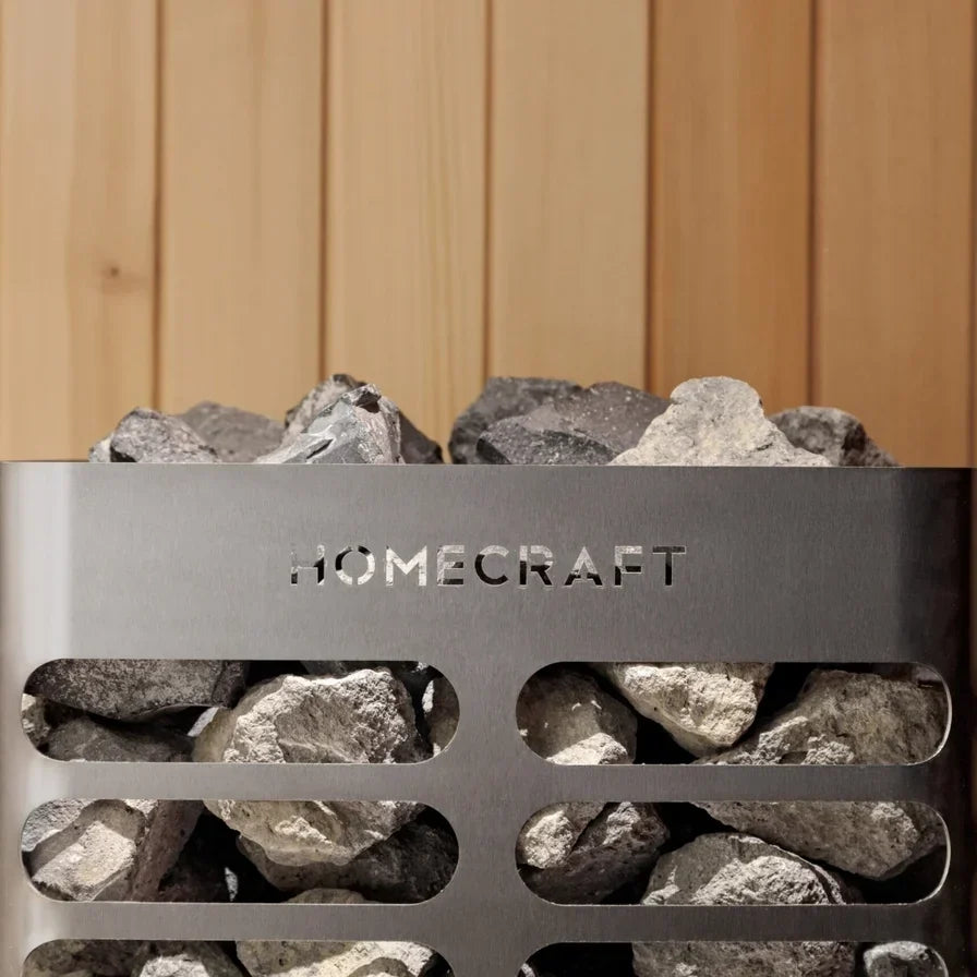 Close-up of Homecraft electric sauna heater rock tray with stainless label and stones