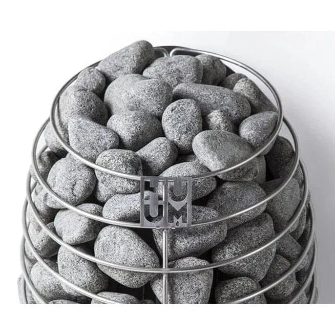 Electric sauna heater with gray sauna stones and HUUM logo label
