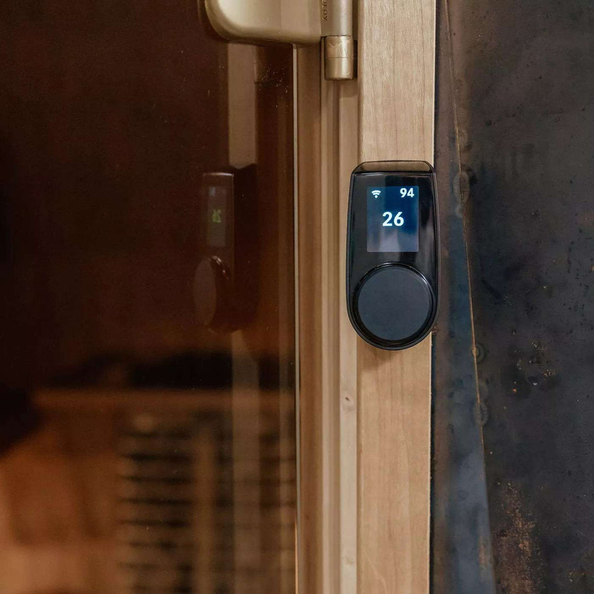 HUUM UKU control unit with digital display mounted on a sauna wall