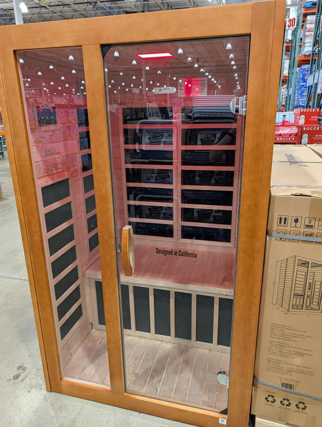 Wood-framed infrared sauna with two glass doors and visible interior heating panels